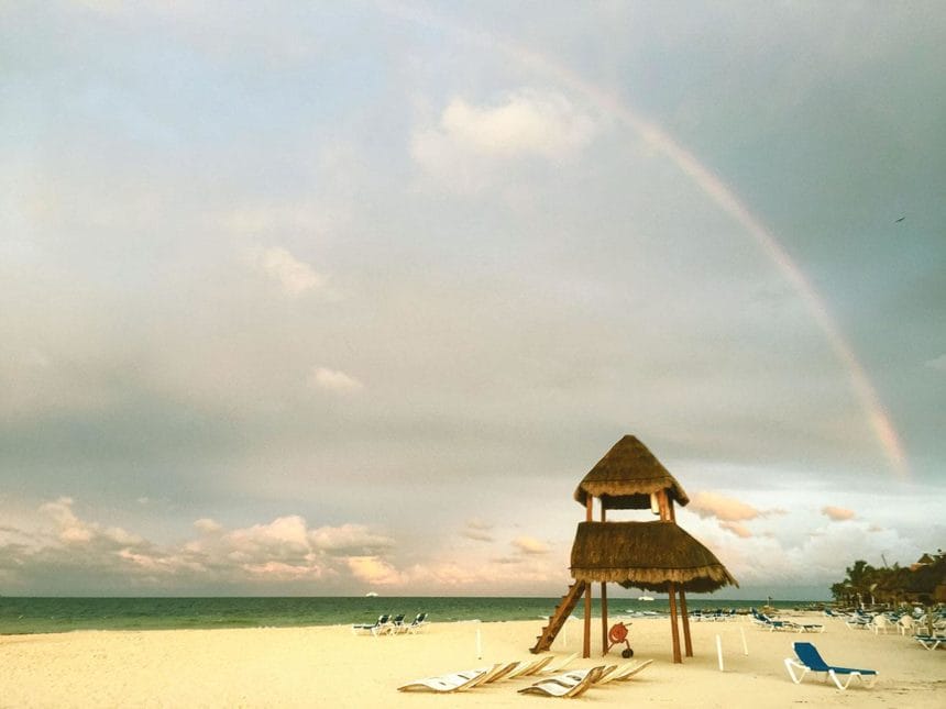 beach with rainbow in the sky