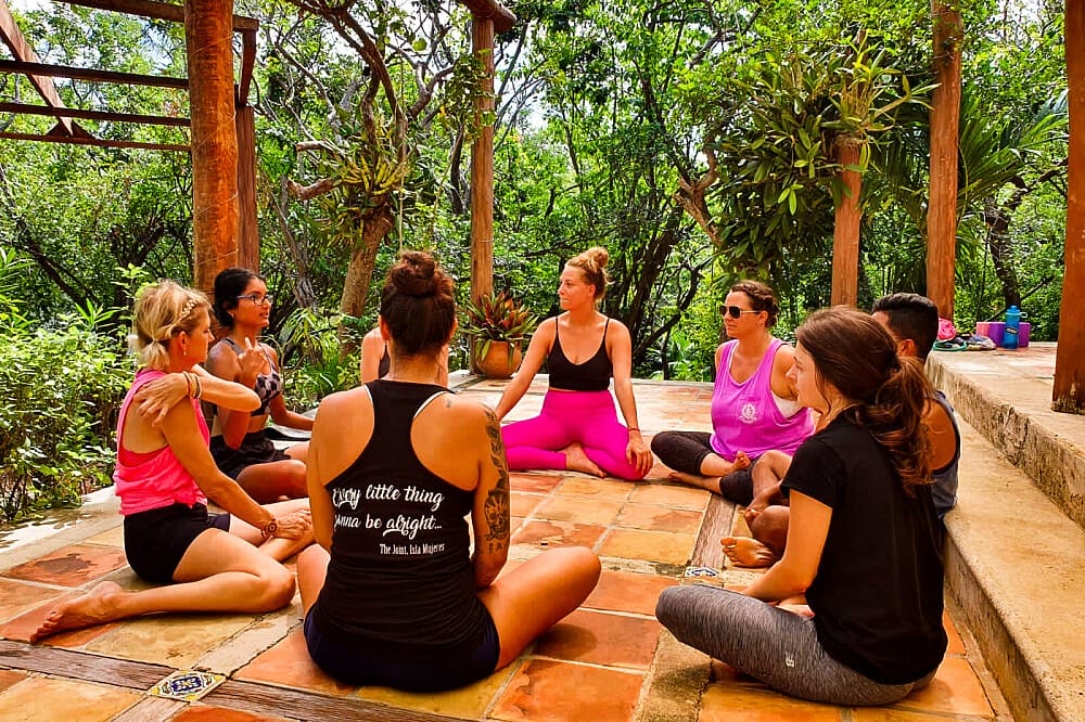 girls practicing yoga with a teacher